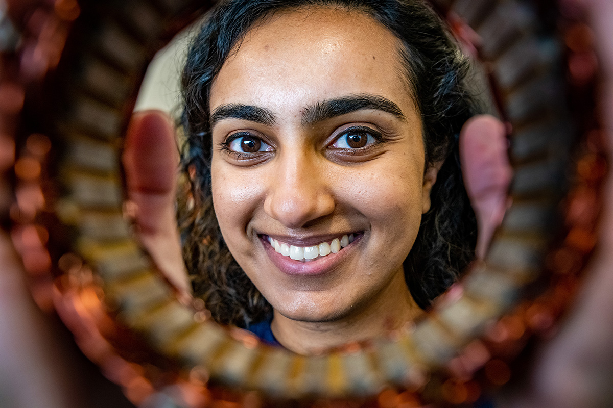 Female student looking through a tube